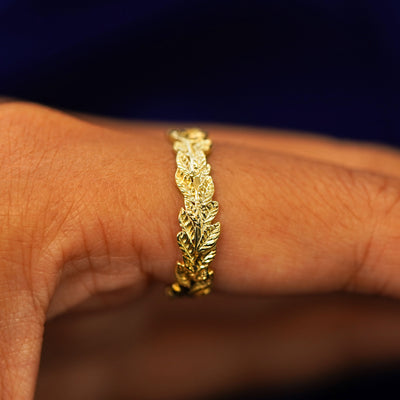 Side view of a Double Leaves Band on a model's finger to show details