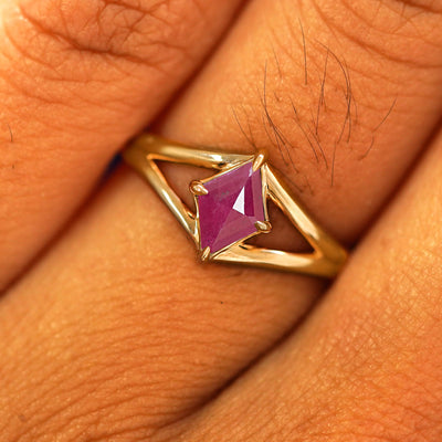 Close up view of a model's fingers wearing a 14k yellow gold Ruby Kite Ring