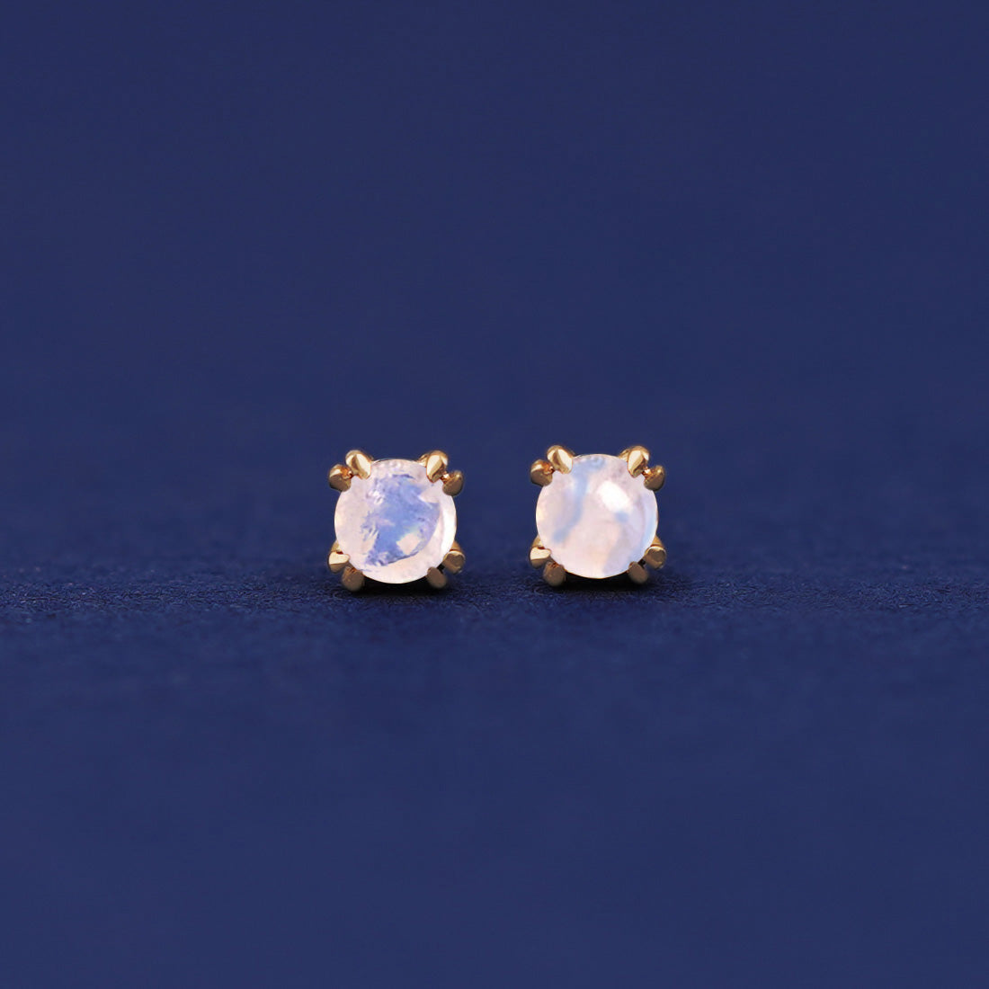 A pair of 14 karat gold studs earrings with 3 millimeter round Moonstone gemstones