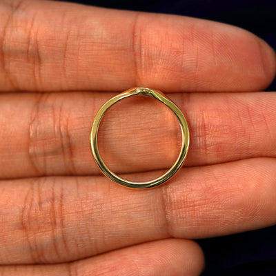 A yellow gold Oval Signet Ring in a model's hand showing the thickness of the band