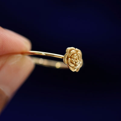 A model holding a Rose Ring tilted to show the side of the ring