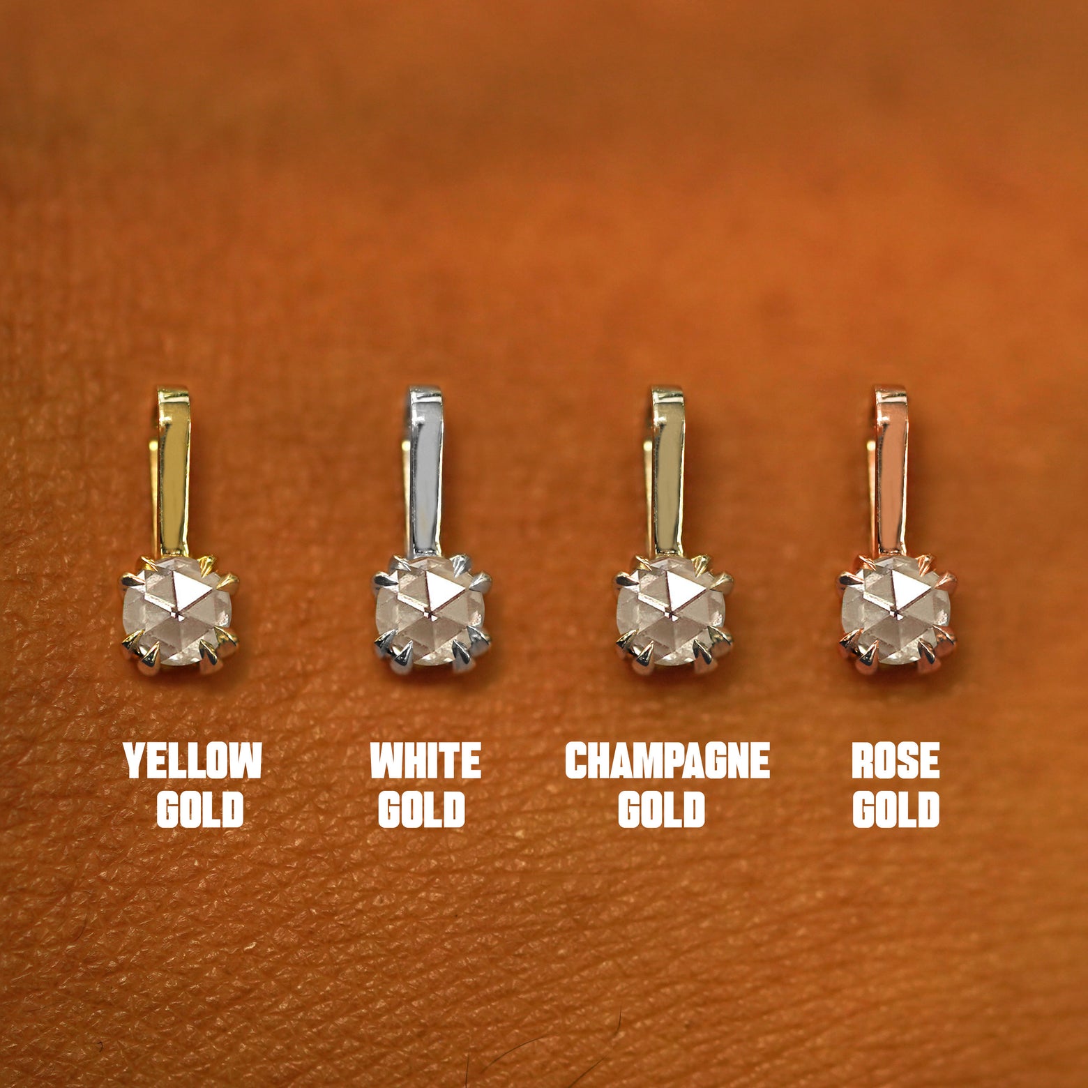 Four versions of the Rose Cut Diamond Charm shown in options of yellow, white, rose, and champagne gold