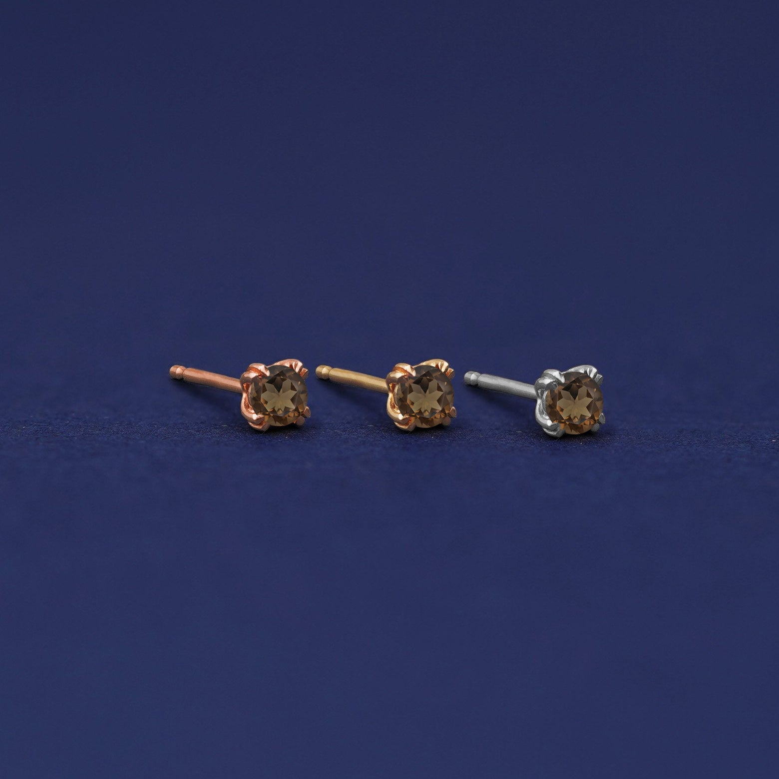 Three versions of the Smoky Quartz Earring shown in options of rose, yellow, and white gold