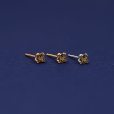 Three versions of the Smoky Quartz Earring shown in options of rose, yellow, and white gold