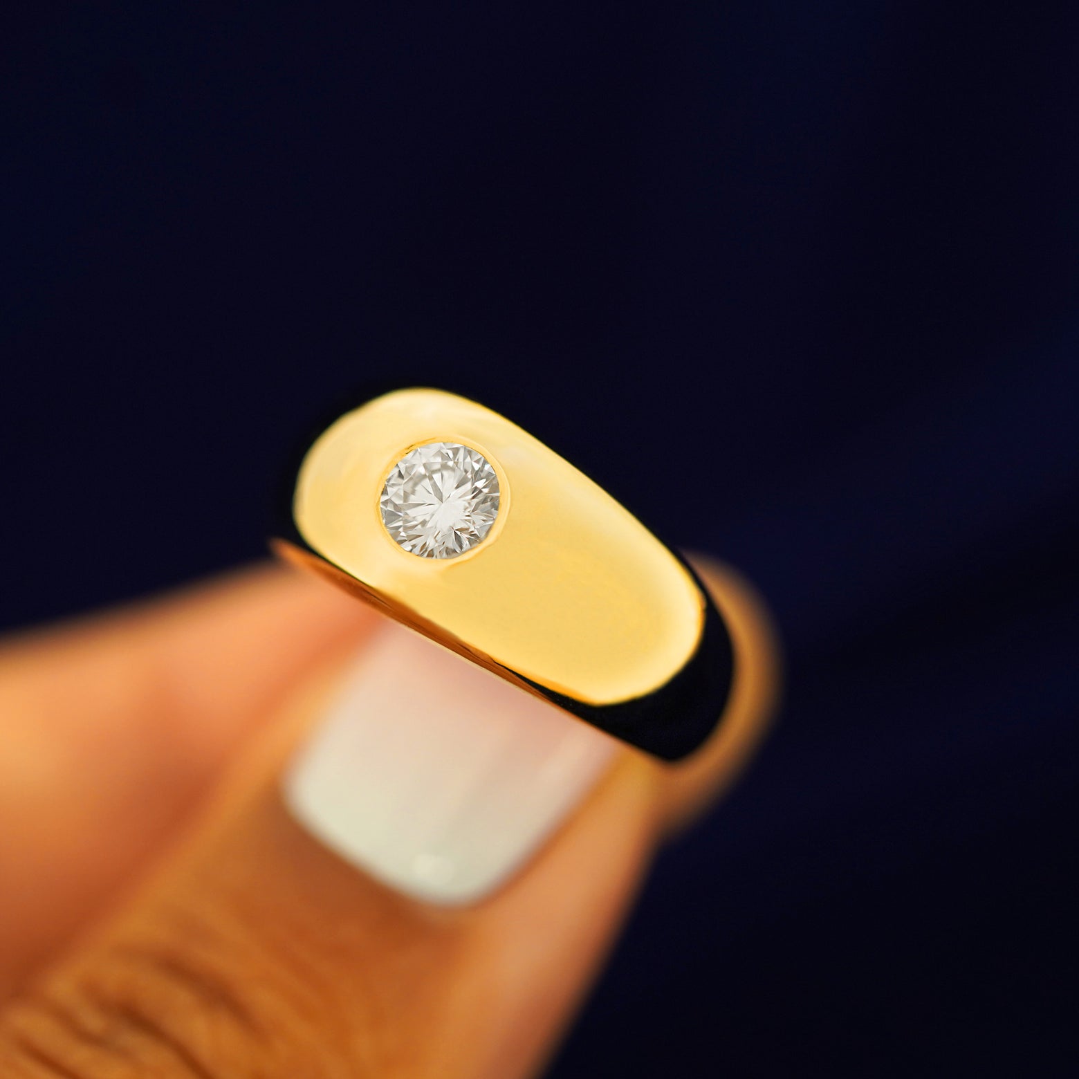 A model holding a Round Lab Diamond Puffy Signet Ring tilted to show the side of the band