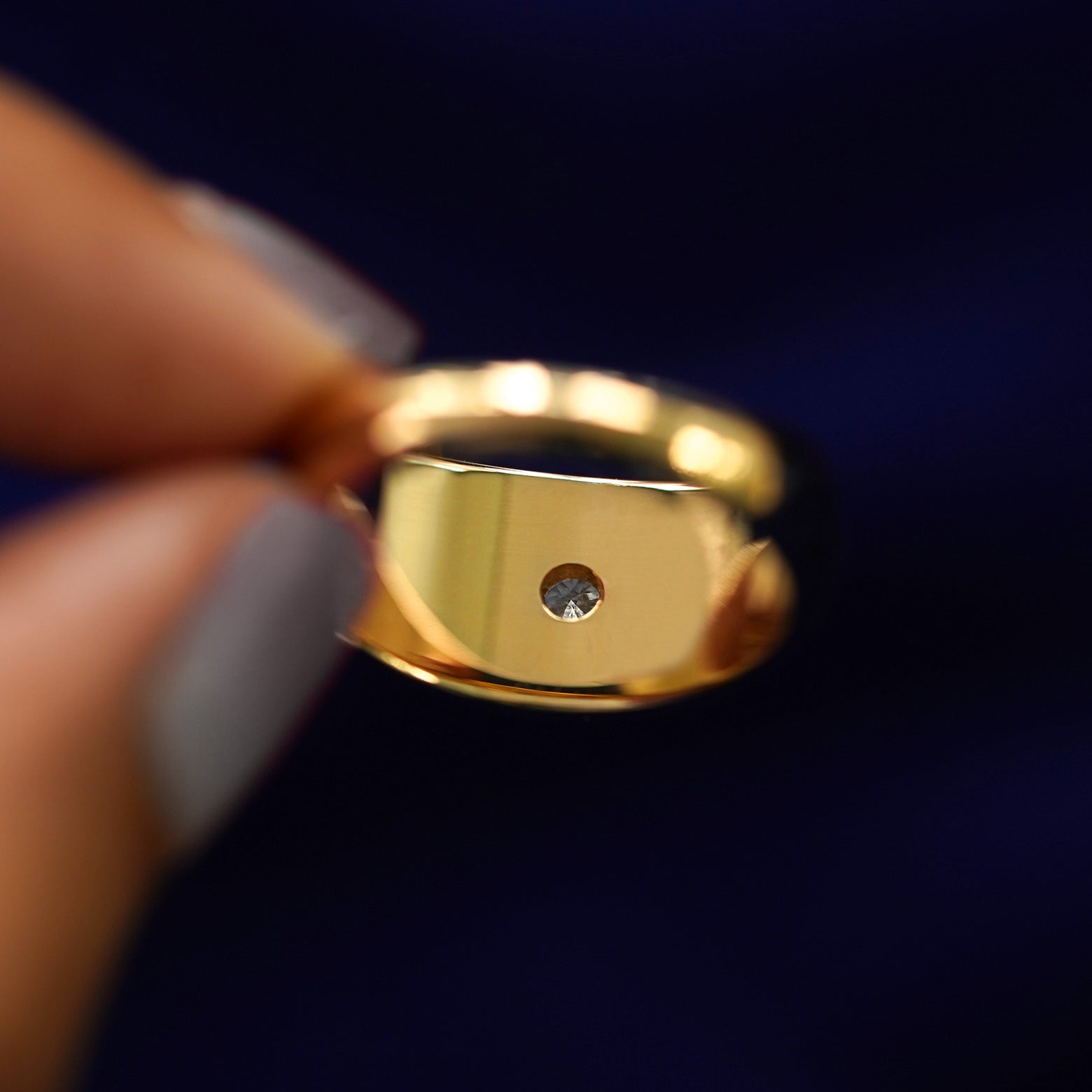 Underside view of a solid 14k gold Round Lab Diamond Puffy Signet Ring to show diamond setting