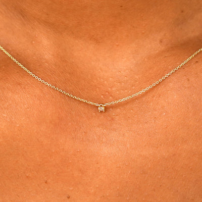 Close up view of a model's neck wearing a solid 14k yellow gold Diamond Cable Necklace