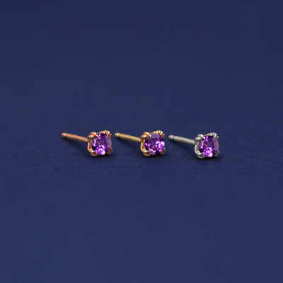 Three versions of the Amethyst Earring shown in options of rose, yellow, and white gold