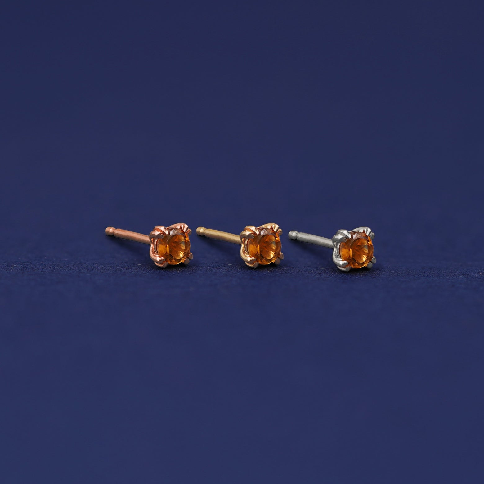 Three versions of the Citrine Earring shown in options of rose, yellow, and white gold