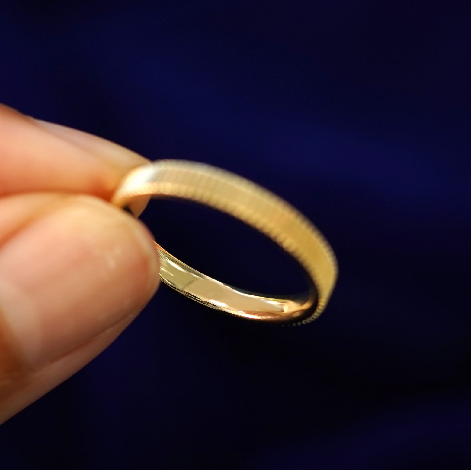 Underside view of a solid 14k gold Edge Band