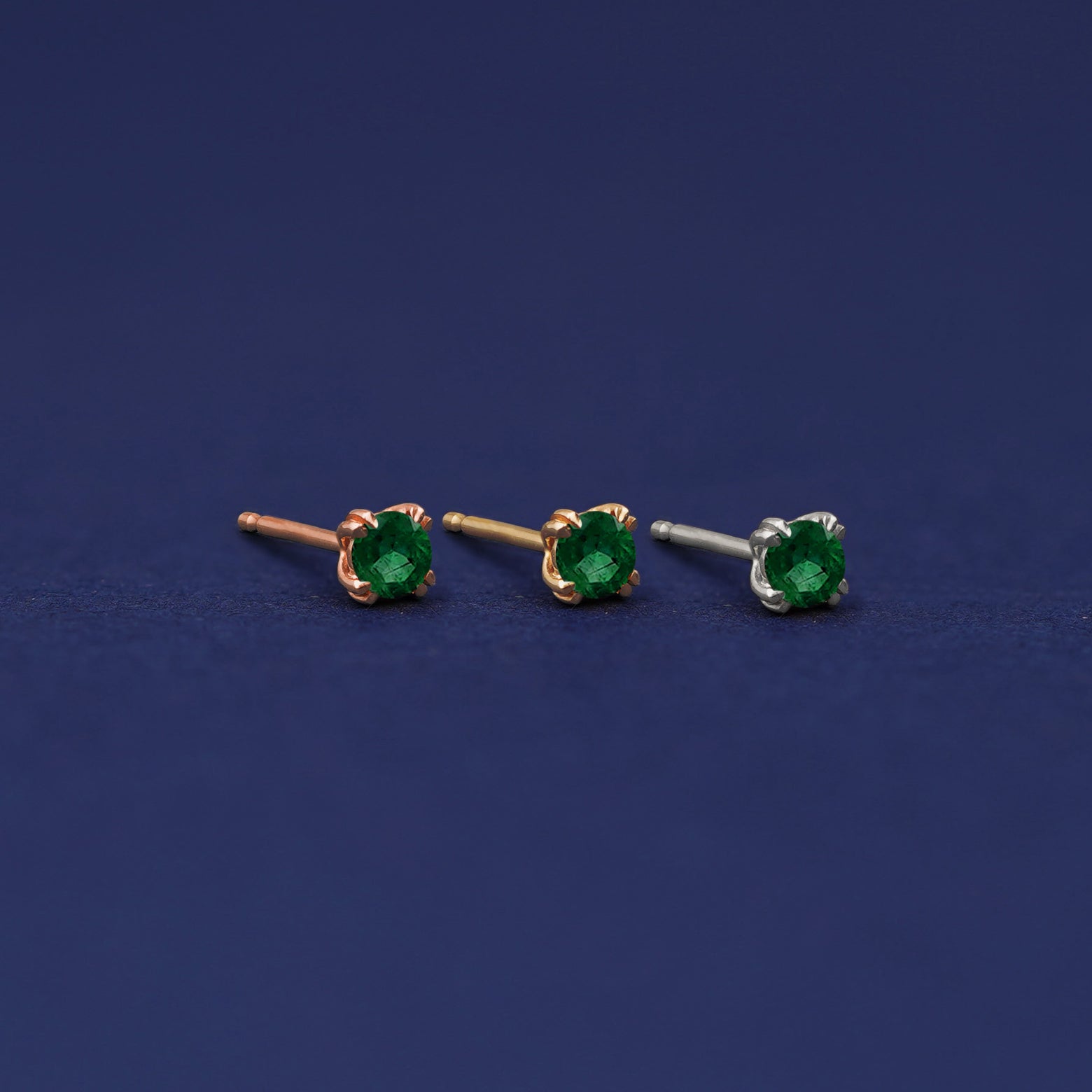 Three versions of the Emerald Earring shown in options of rose, yellow, and white gold