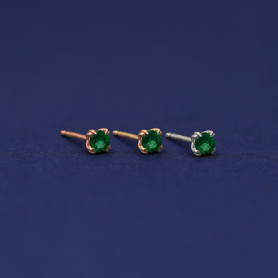 Three versions of the Emerald Earring shown in options of rose, yellow, and white gold