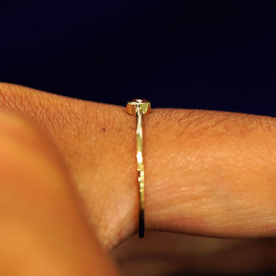 Side view of a Garnet Ring on a model's finger