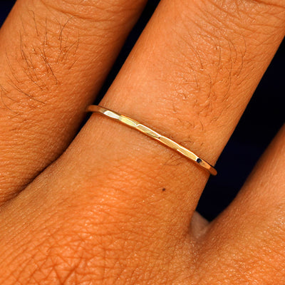 Close up view of a model's fingers wearing a 14k yellow gold Hammered Ring