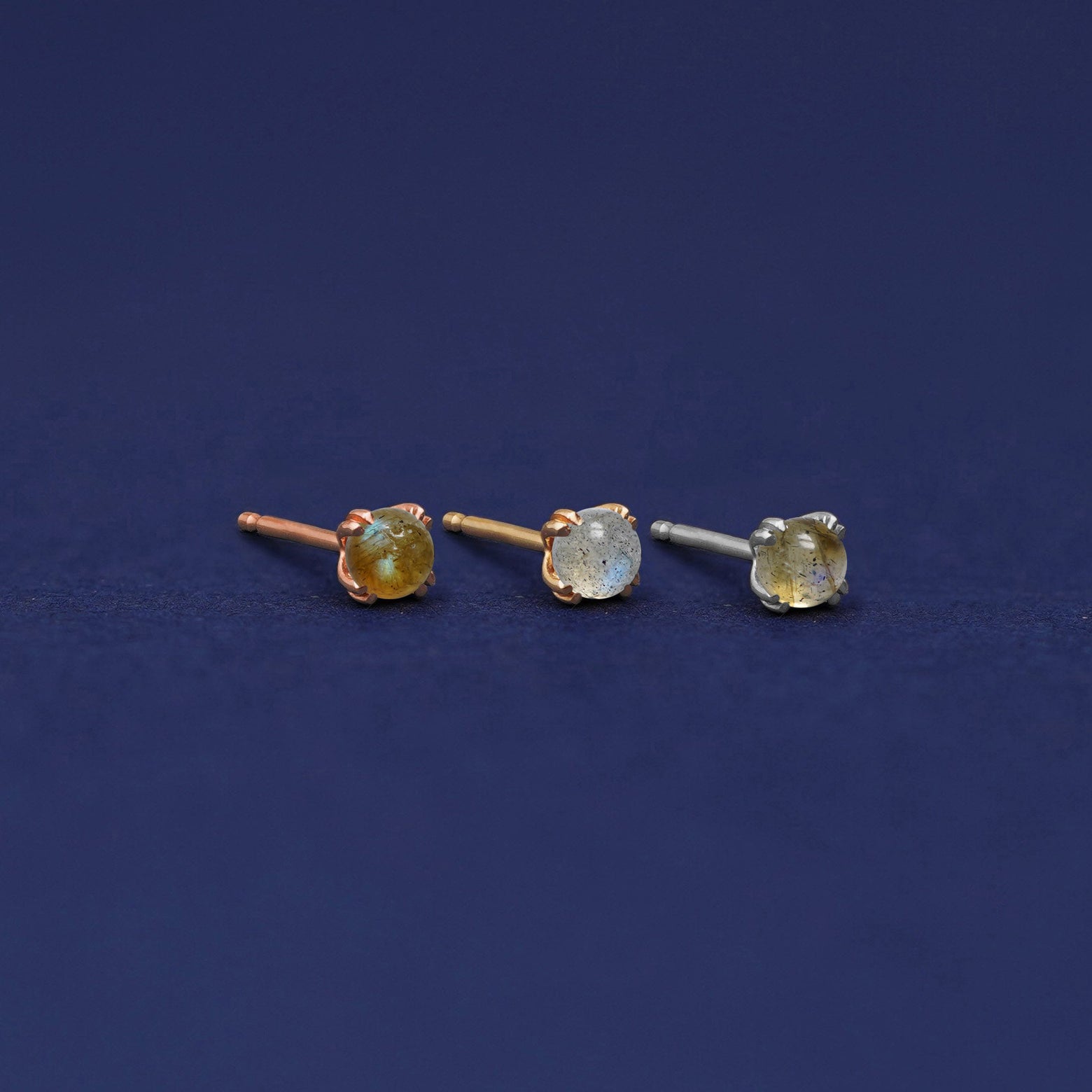 Three versions of the Labradorite Earring shown in options of rose, yellow, and white gold