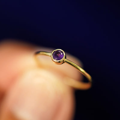 A model holding an Amethyst Ring tilted to show the bezel setting