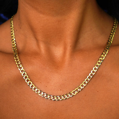 Close up view of a model's neck wearing a yellow gold Curb Chain 