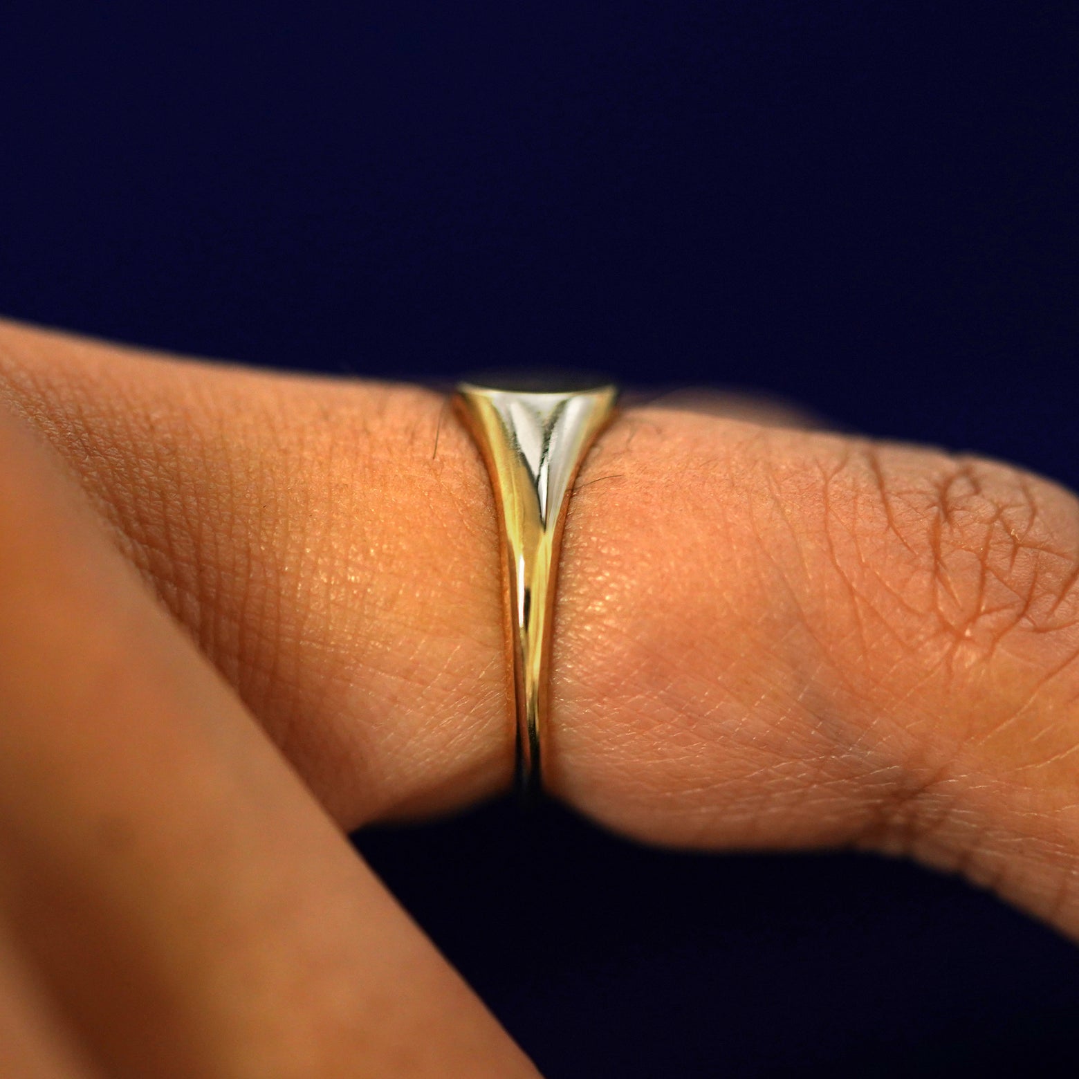Side view of a Signet Ring on a model's finger