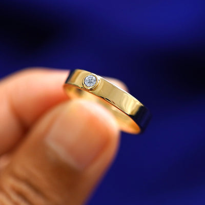 A model holding a Diamond Industrial Band tilted to show the side of the ring