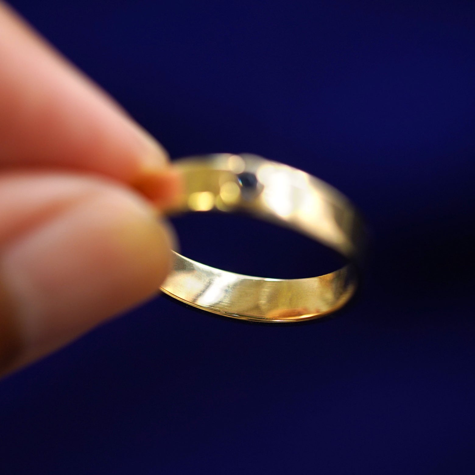 Underside view of a solid 14k gold sapphire Gemstone Industrial Band