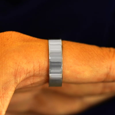 Side view of a Platinum Industrial Mirror Band on a model's finger