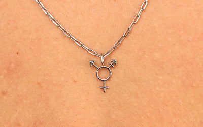 Close up view of a model wearing a white gold Trans Symbol Charm on a Butch Chain