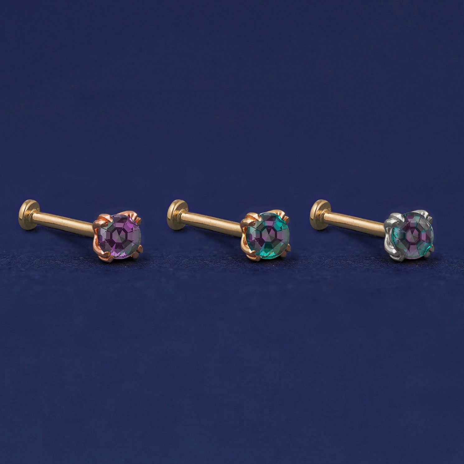 Three versions of the Alexandrite Flat Back Earring shown in options of rose, yellow, and white gold