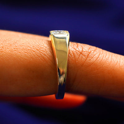 Side view of an Asscher Moissanite Signet Ring on a model's finger