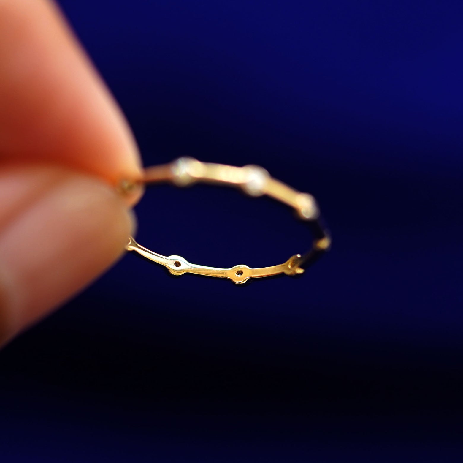 Underside view of a solid 14k gold Spaced Infinity Ring