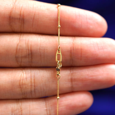 An Automic Gold AU lobster claw clasp on a Beaded Essential Lariat