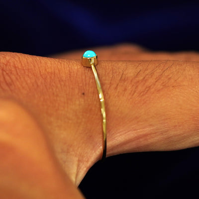Side view of a Turquoise Ring on a model's finger