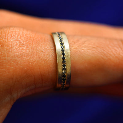 Side view of a Endless Diamond Band on a model's finger