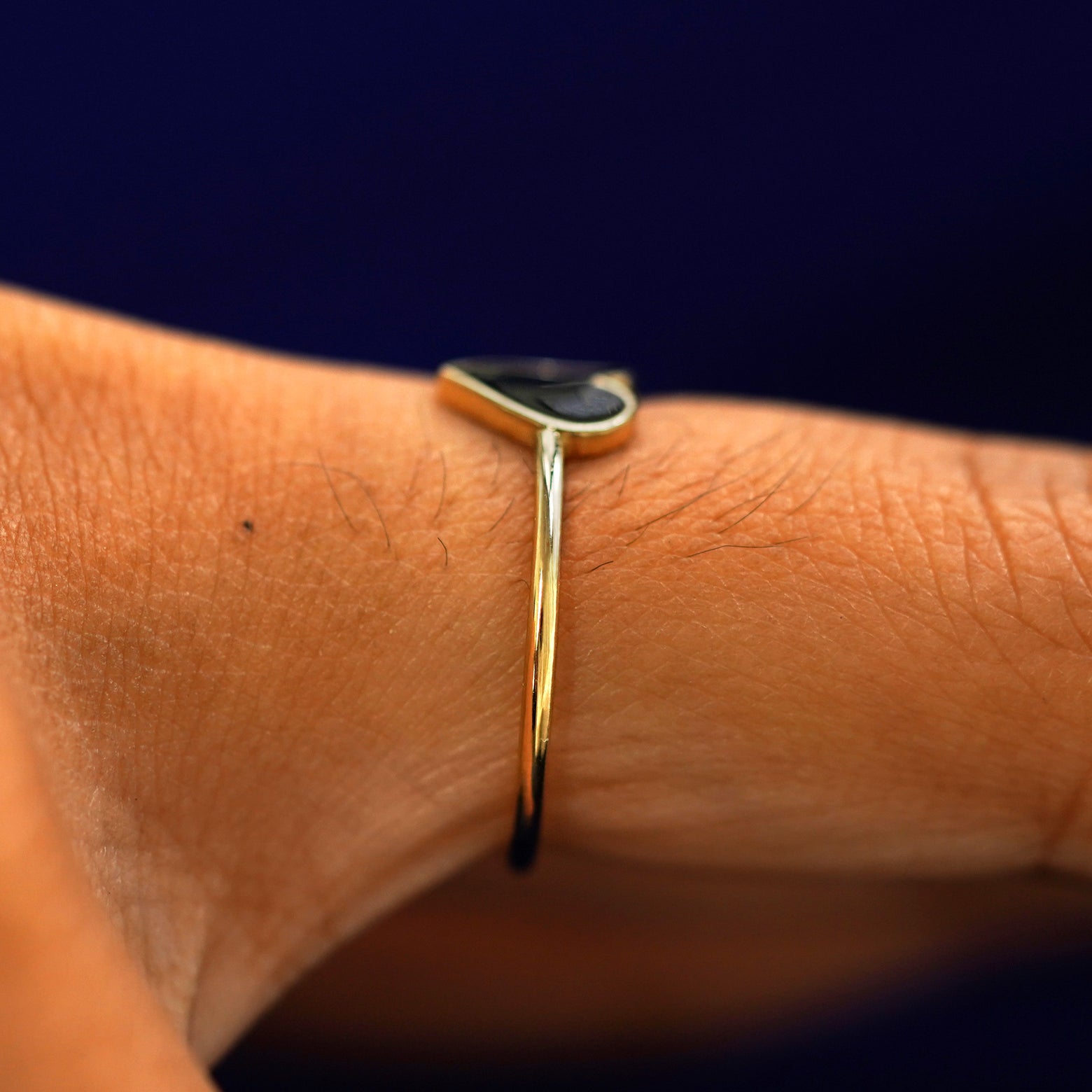 Side view of a Enamel Heart Ring on a model's finger