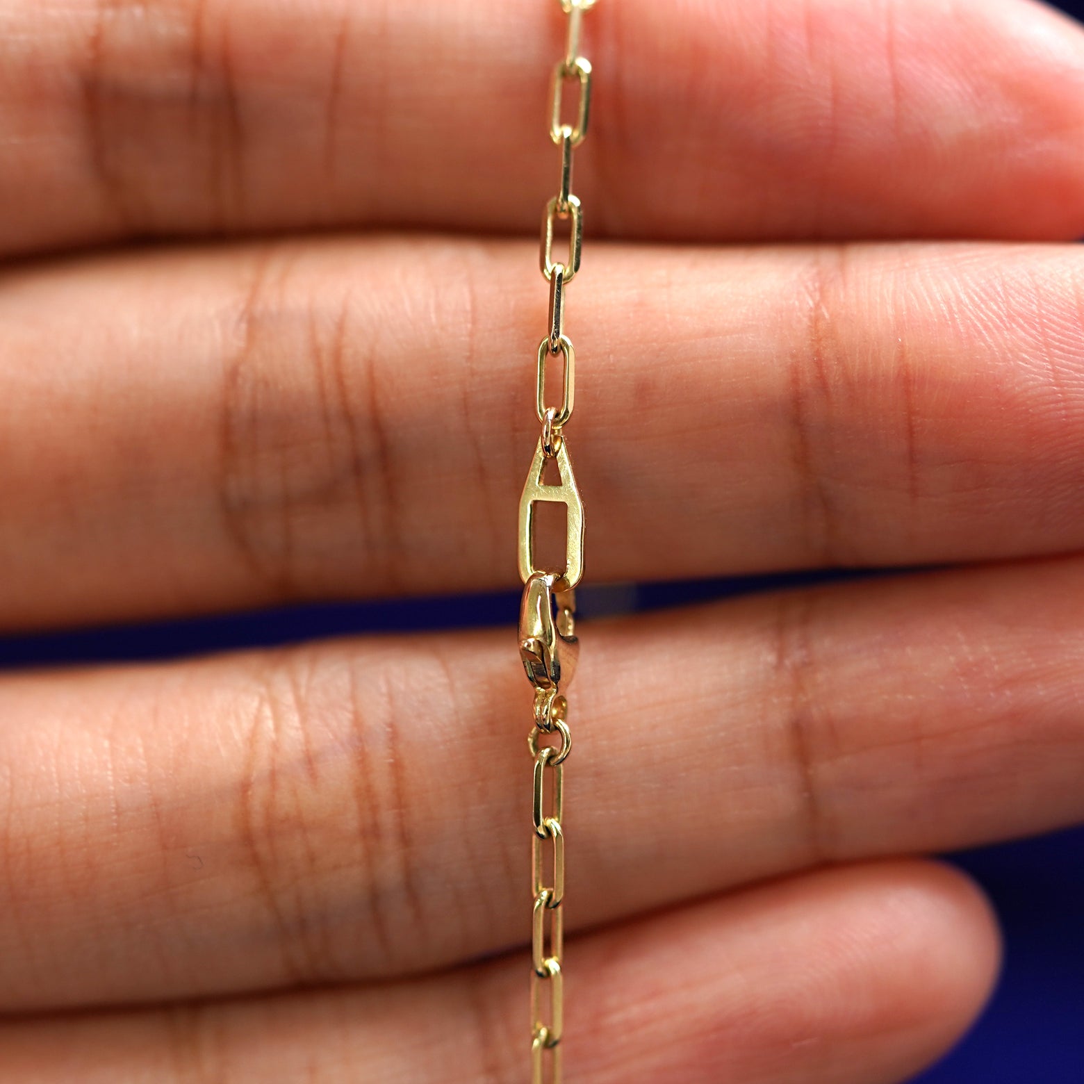 An Automic Gold AU lobster claw clasp on a Butch Chain Wrap Necklace