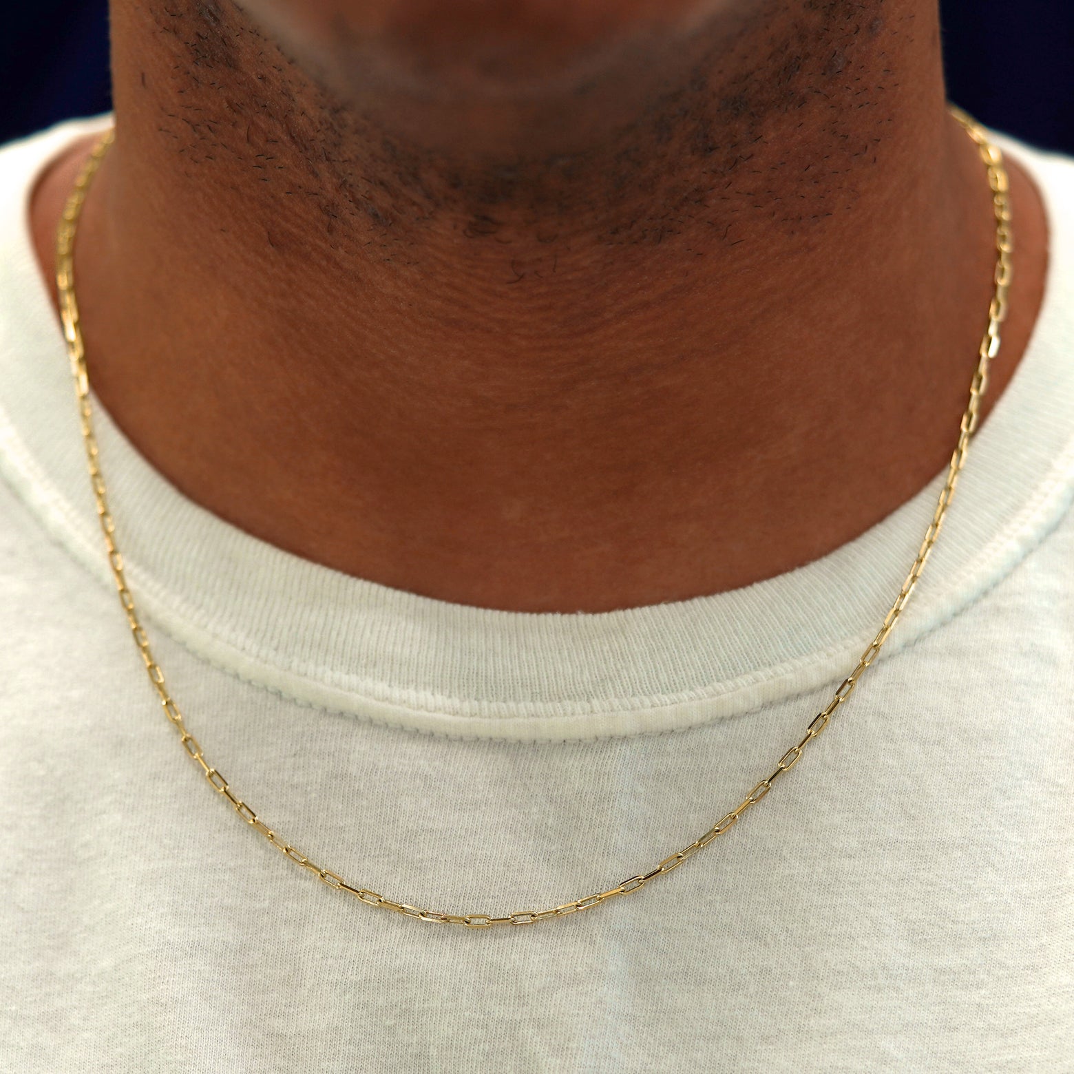 A model in a white shirt wearing a solid yellow gold Butch Chain