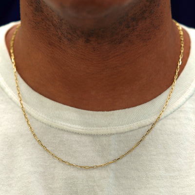 A model in a white shirt wearing a solid yellow gold Butch Chain