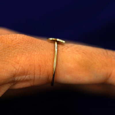 Side view of a Butterfly Ring on a model's finger