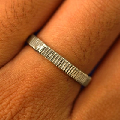 Close up view of a model's fingers wearing a 14k champagne gold Edge Band