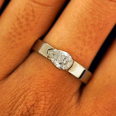 Close up view of a model's fingers wearing a 14k champagne gold Lab Diamond Pear Ring