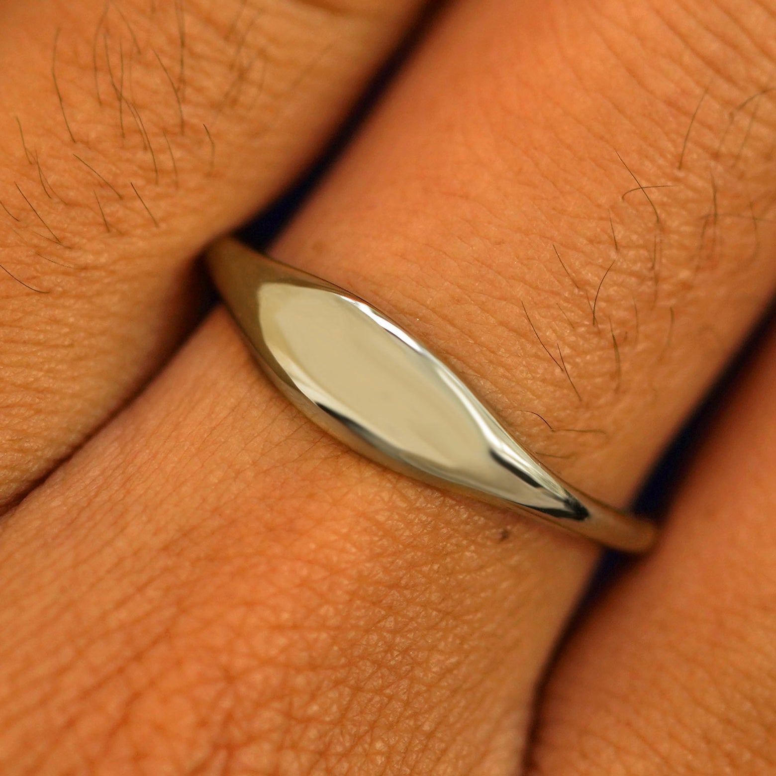 Close up view of a model's fingers wearing a 14k champagne gold Puffy Elongated Signet Ring