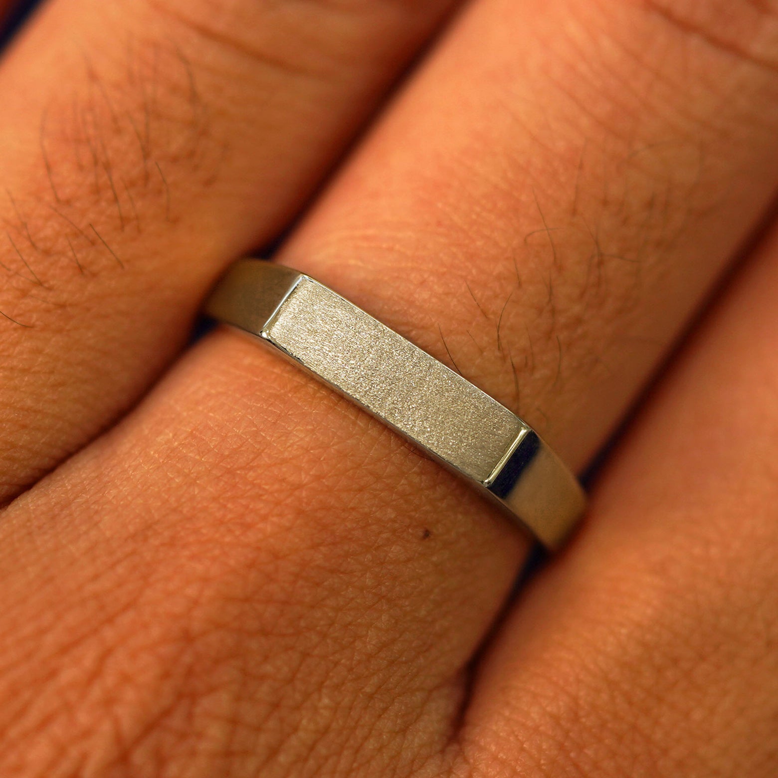 Close up view of a model's fingers wearing a 14k champagne gold Rectangular Signet Ring