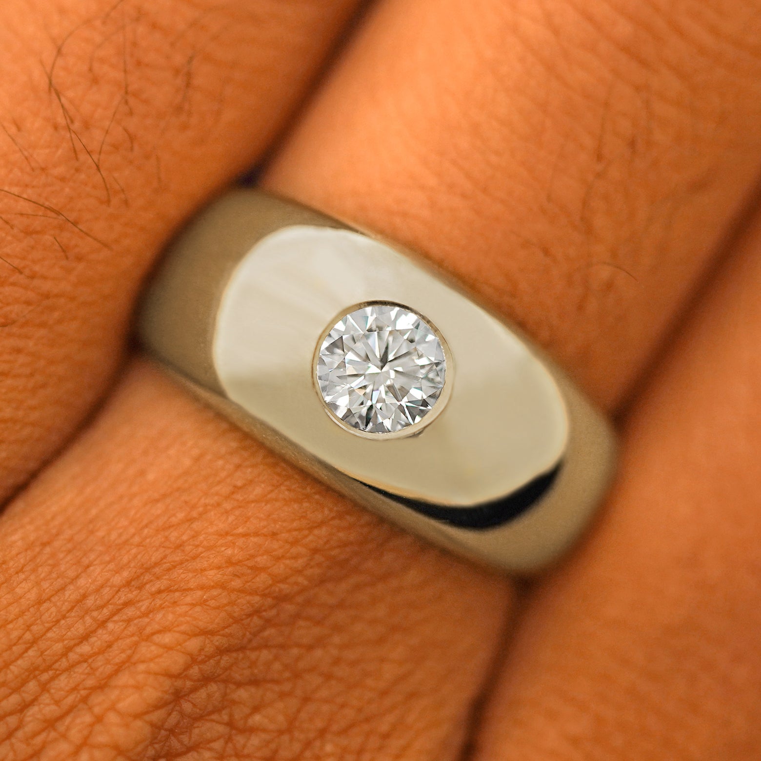 Close up view of a model's fingers wearing a 14k champagne gold Round Lab Diamond Puffy Signet Ring