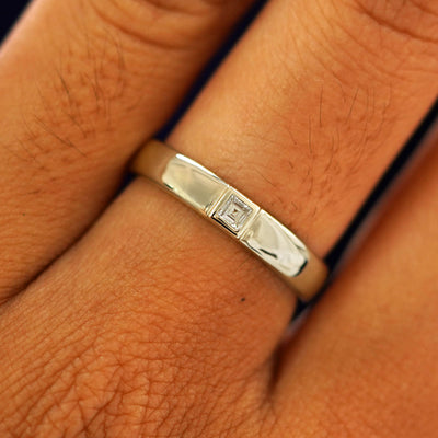 Close up view of a model's fingers wearing a 14k champagne gold Square Carre Cut Diamond Band