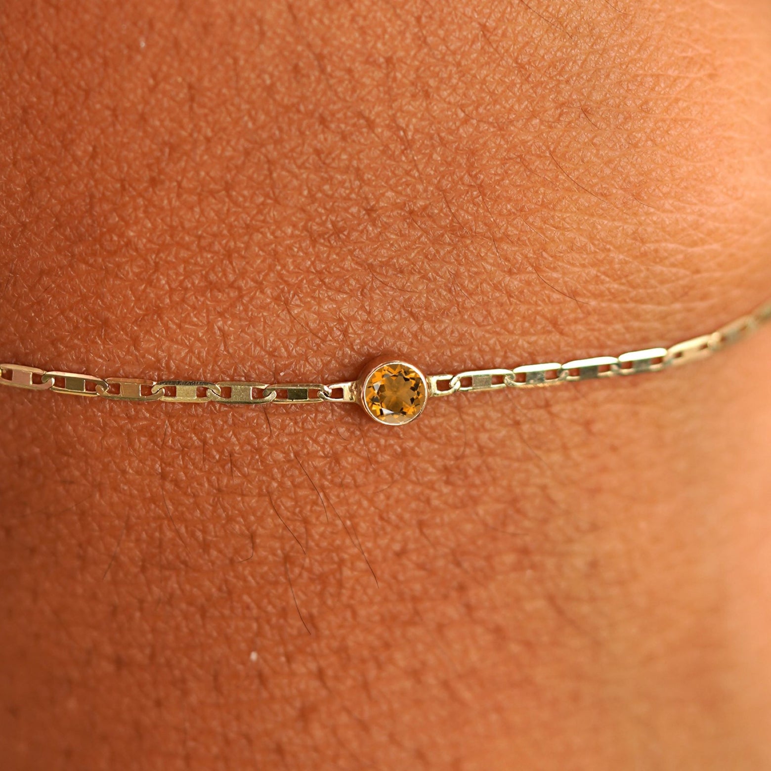 Close up view of a models wrist wearing 14k yellow gold Citrine Bracelet