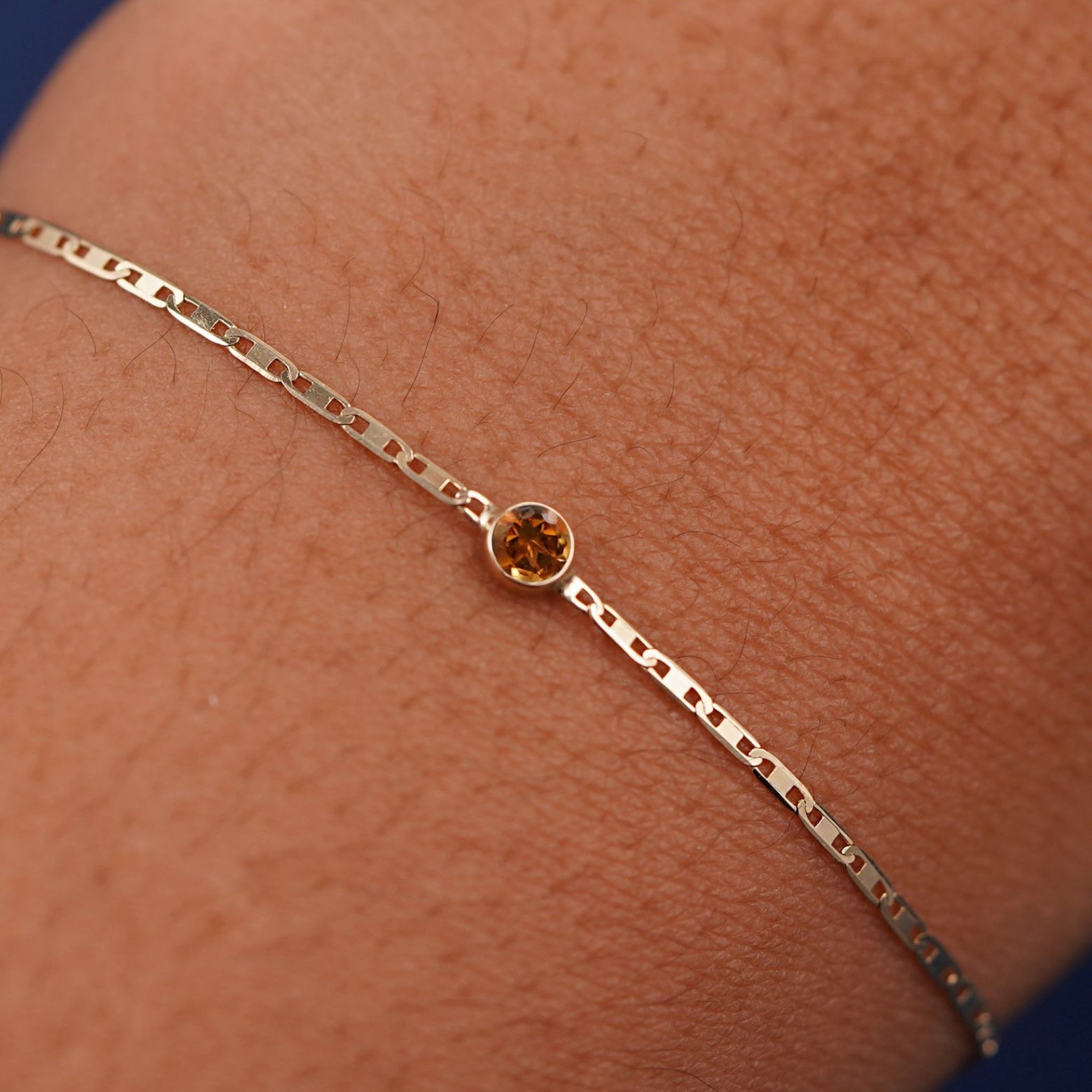 Close up view of a models wrist wearing 14k yellow gold Citrine Bracelet