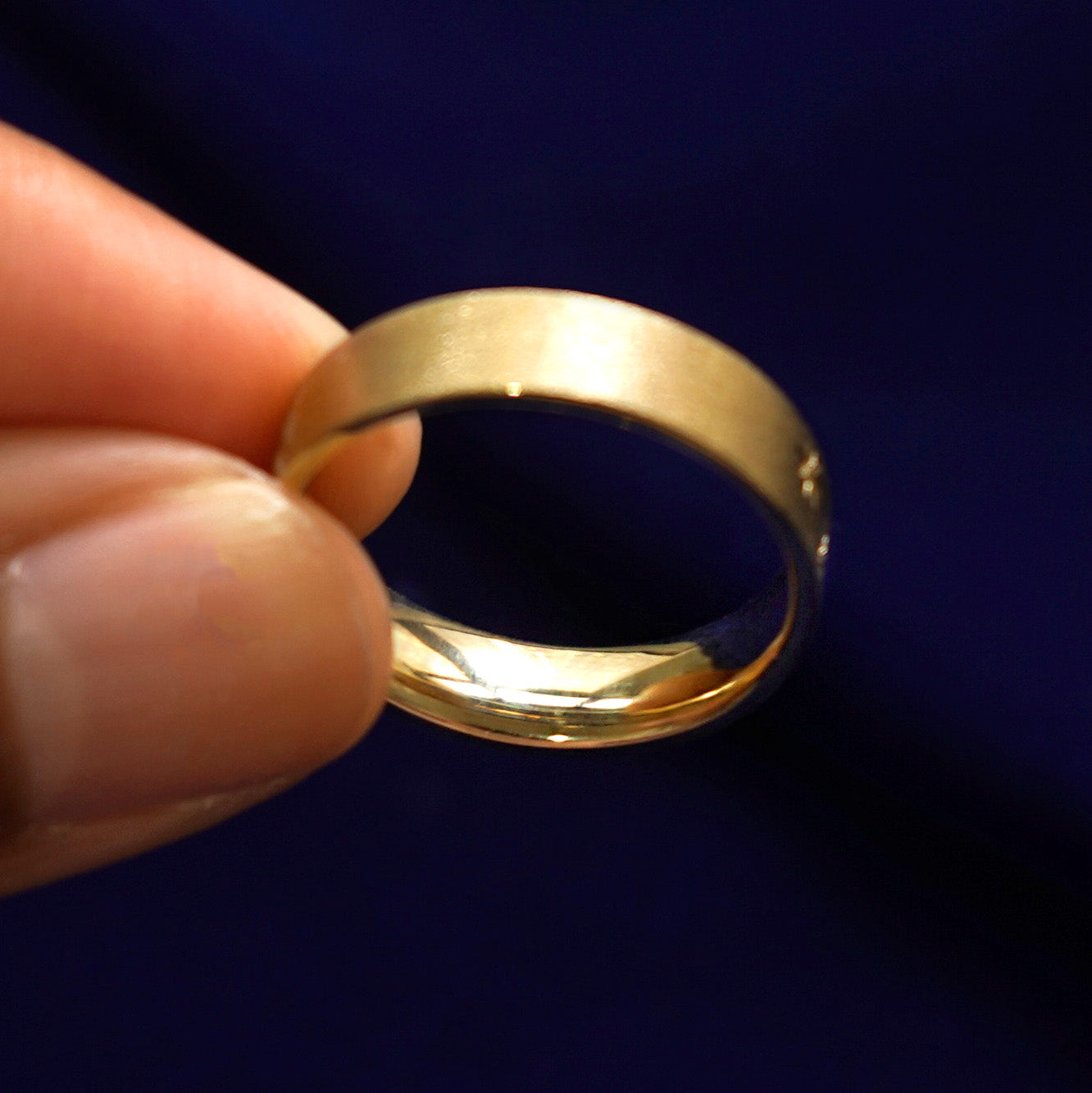 A model holding a Cloud Diamond Band tilted to show the inside of the ring