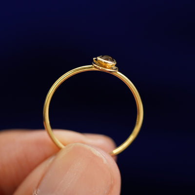 A model holding a Coffee Cup Ring up to show the detail of the cup