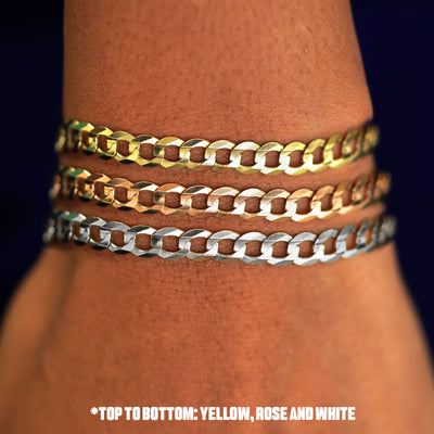 Close up view of a model's wrist wearing three versions of the Curb Anklet in options of rose, yellow, and white gold