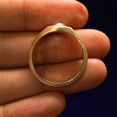 A Cushion Salt and Pepper Diamond Signet Ring in a model's hand showing the thickness of the band and the height of the ring