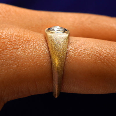 Side view of a Cushion Salt and Pepper Diamond Signet Ring on a model's finger to show the hidden halo